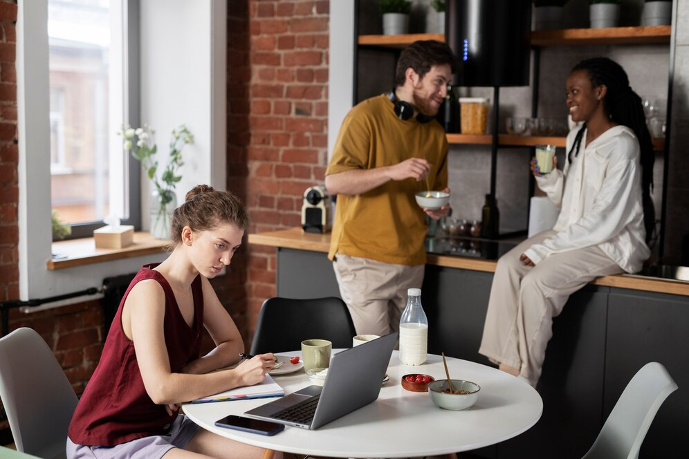 Careers 11 Team members working and connecting over breakfast in a relaxed office setting.