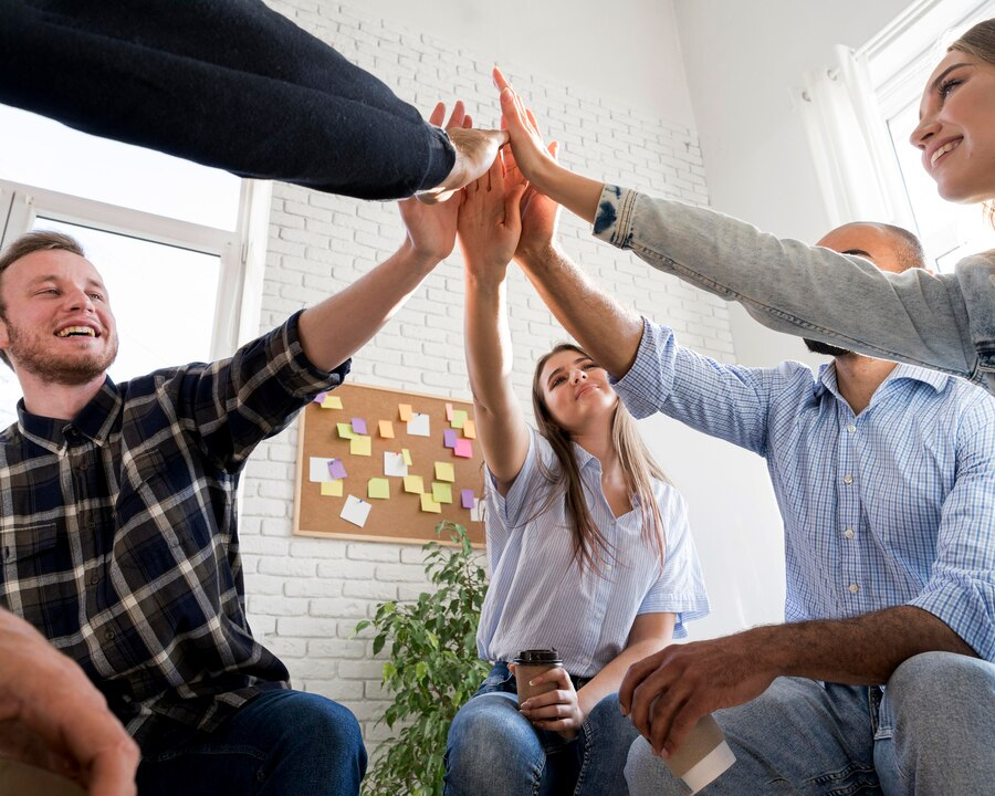 Careers 2 DeepForrest diverse team celebrating success in a creative workspace.