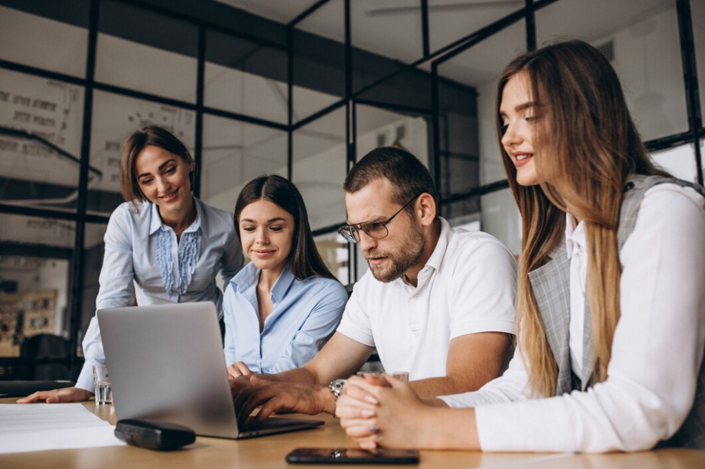 About Us 6 DeepForrest team analyzing an AI-driven healthcare solution during office collaboration.