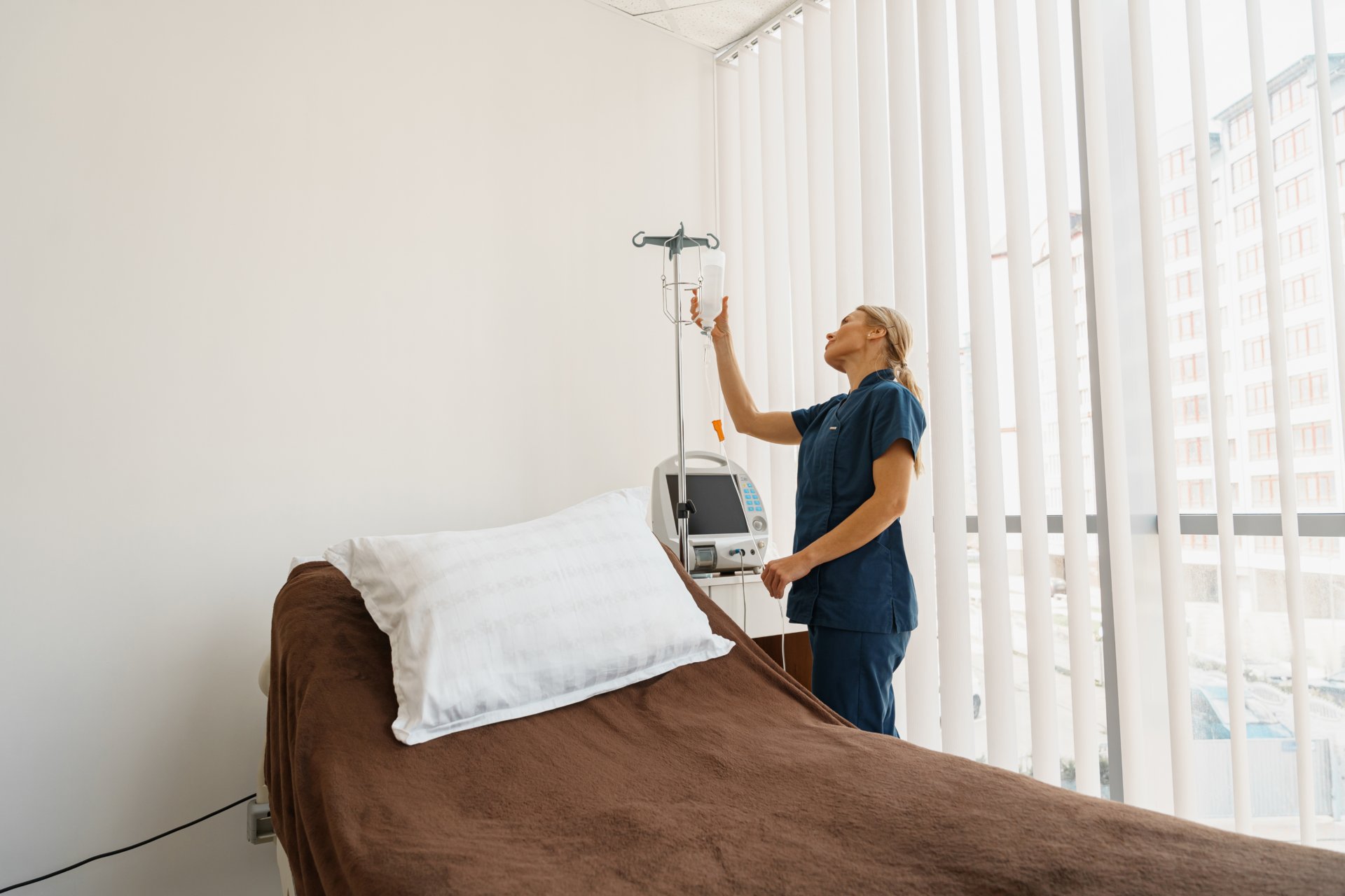 Clinical Intelligence & Decision Support 8 Nurse preparing hospital bed and IV equipment, representing efficient resource utilization through bed occupancy prediction