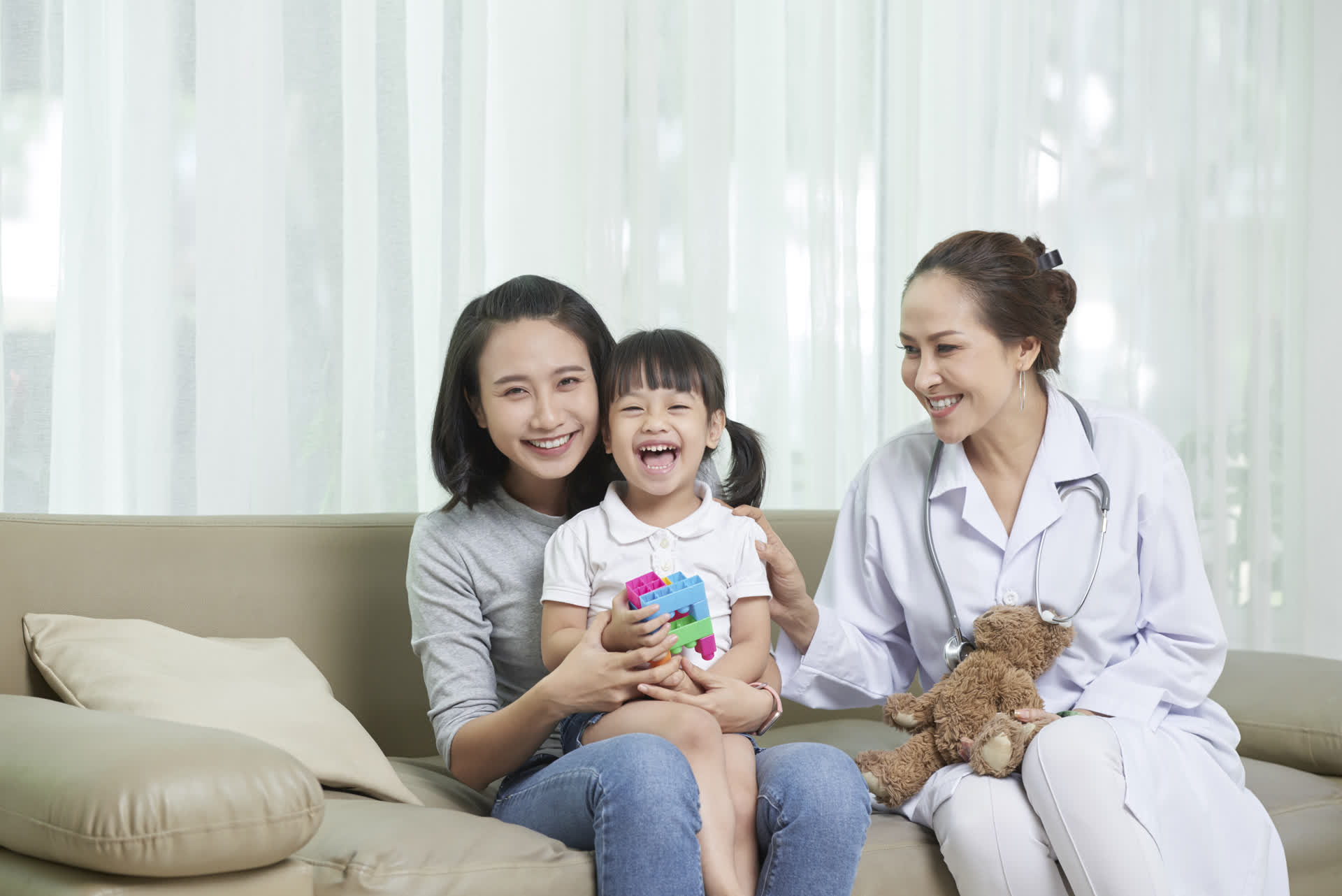 Patient Retention & Referral Management 1 Smiling doctor with mother and child during a healthcare visit, representing patient satisfaction and trust in care journey