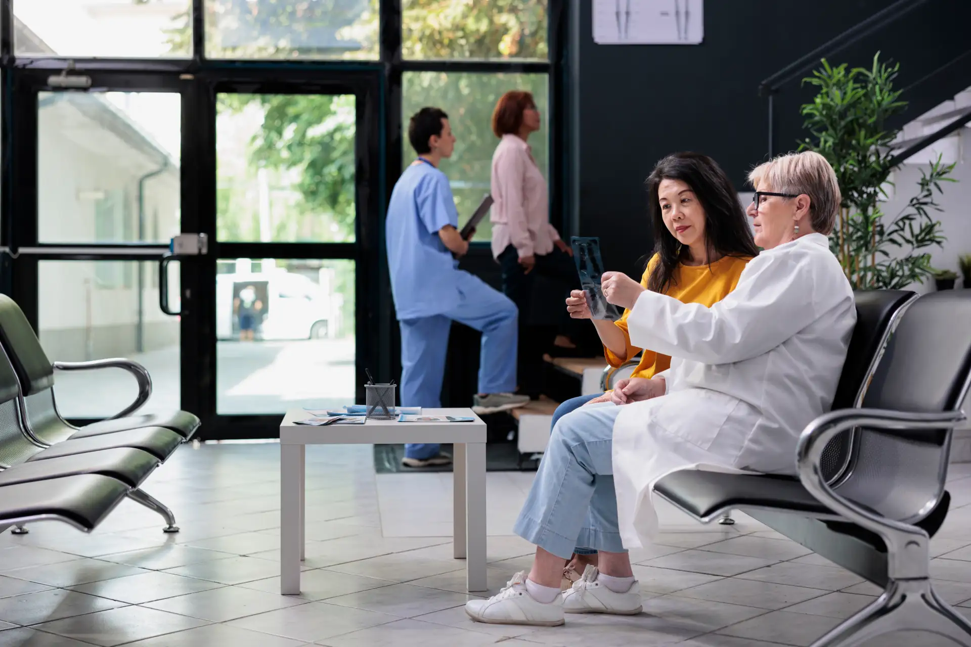 Clinical Intelligence & Decision Support 1 Doctor discussing X-ray results with patient in hospital waiting area, highlighting personalized clinical decision support.